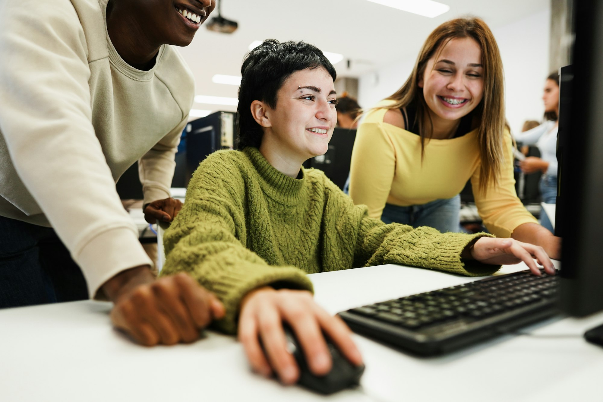 Young students using computers inside business class at school - Focus on center girl eye